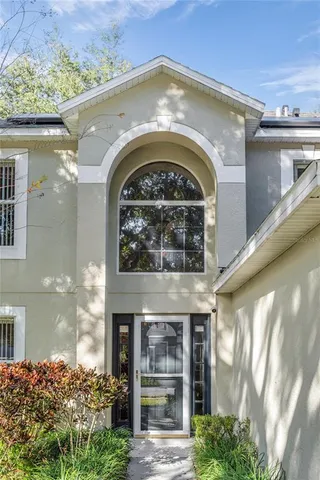 a front view of a house with plants