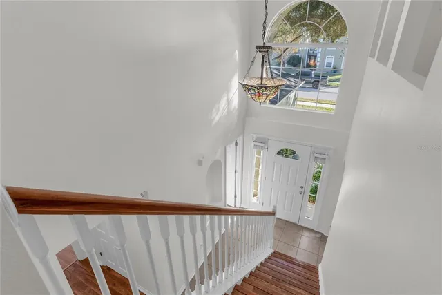 a view of a livingroom with wooden floor and a white door