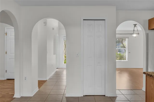 a view of an empty room with wooden floor and windows