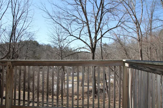 a view of wooden fence and trees