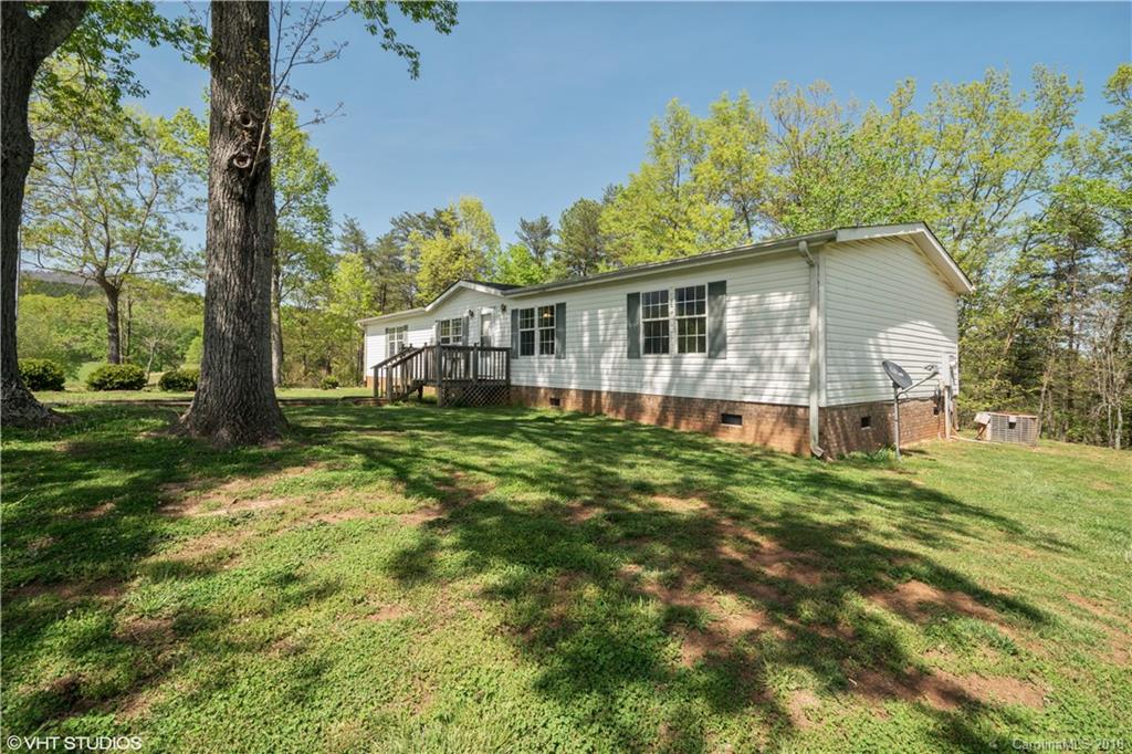 662 Lake Adger Road Mill Spring, NC 28756 - Photo 1 of 20 front view of a house with a big yard