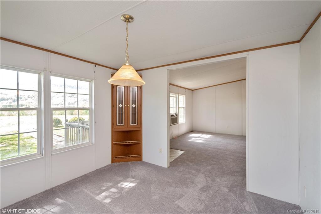 662 Lake Adger Road Mill Spring, NC 28756 - Photo 11 of 20 a view of a room with large windows