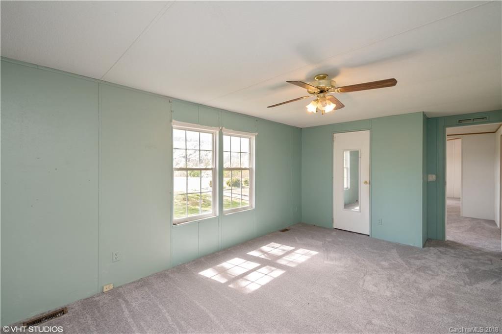 662 Lake Adger Road Mill Spring, NC 28756 - Photo 12 of 20 a view of an empty room with a window