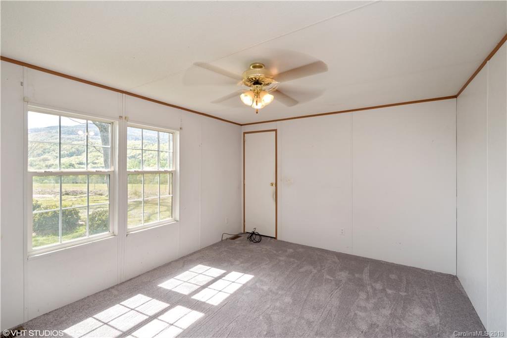 662 Lake Adger Road Mill Spring, NC 28756 - Photo 14 of 20 a view of an empty room with a window
