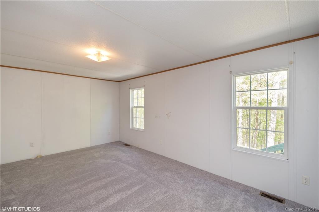 662 Lake Adger Road Mill Spring, NC 28756 - Photo 15 of 20 an empty room with a window