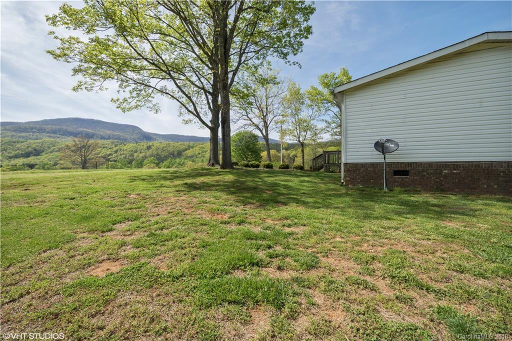 662 Lake Adger Road Mill Spring, NC 28756 - Photo 18 of 20 a backyard of a house with lots of green space