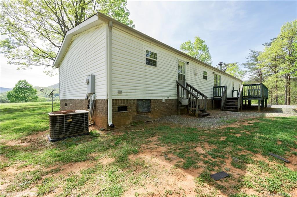 662 Lake Adger Road Mill Spring, NC 28756 - Photo 19 of 20 a view of a house with a yard