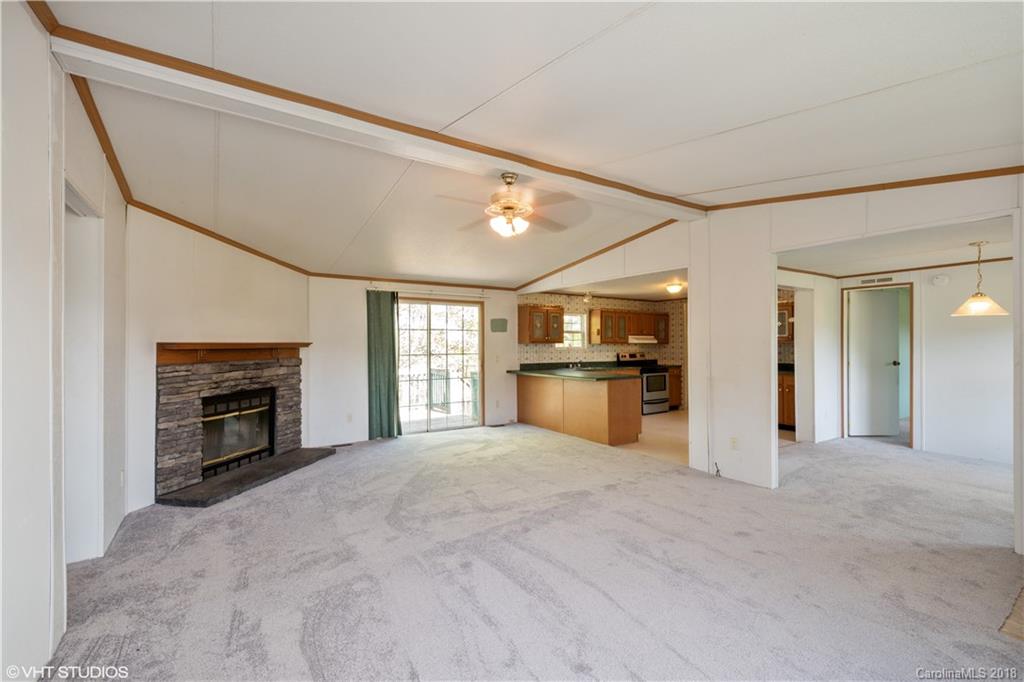 662 Lake Adger Road Mill Spring, NC 28756 - Photo 8 of 20 a view of a kitchen with a sink and a fireplace