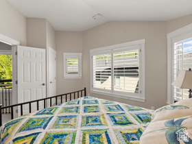 514 North Olympic Way Midway, UT 84049 - Photo 19 of 30 Bright room featuring multiple windows with louvered shutters, a white paneled door, and neutral wall tones