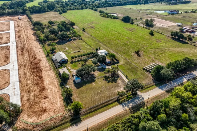 an aerial view of residential houses with outdoor space