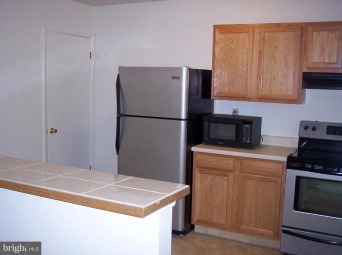 815 Corktree Road, Unit 815 Middle River, MD 21220 - Photo 6 of 13 a kitchen with cabinets and stainless steel appliances