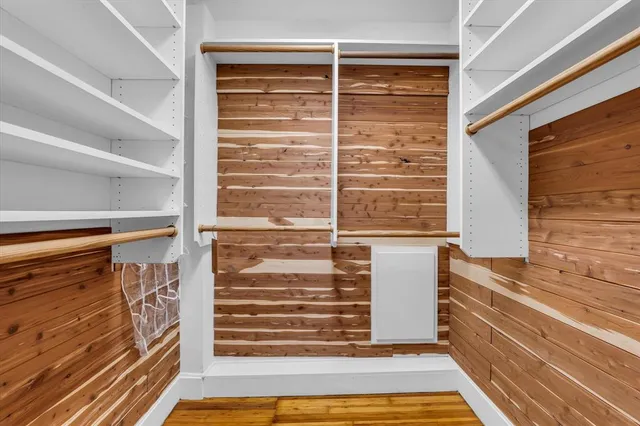 a view of walk in closet with empty racks