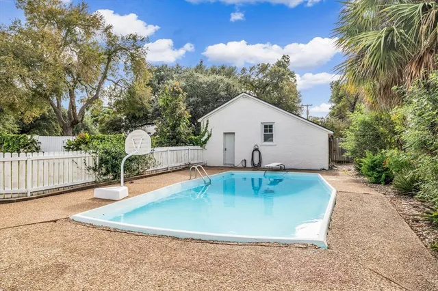 a view of a backyard with swimming pool