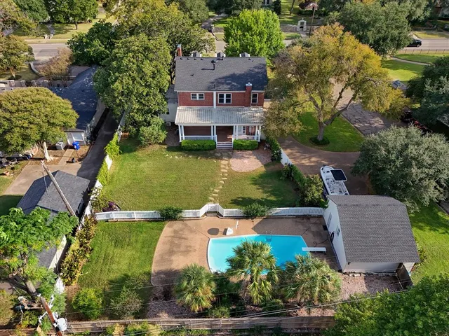 an aerial view of residential houses with outdoor space