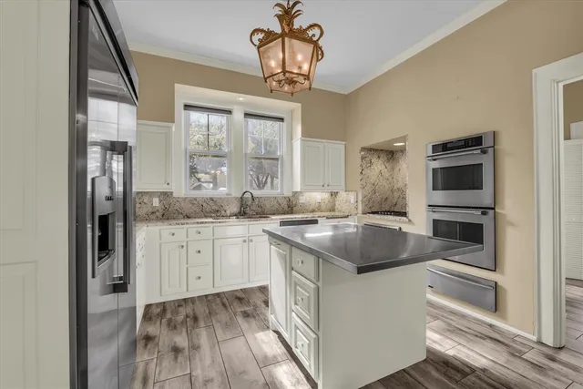 a kitchen with a sink stove and refrigerator