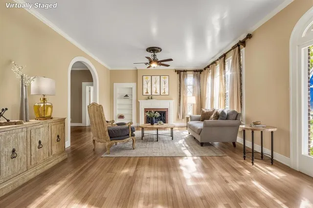 a living room with furniture fireplace and flat screen tv