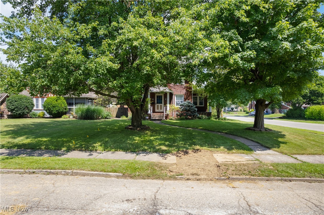 302 Poplar Avenue Northwest Canton, OH 44708 - Photo 2 of 34 View of property hidden behind natural elements with a front lawn