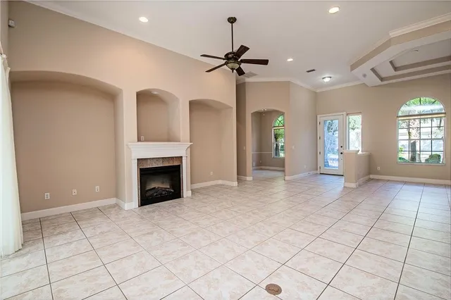 a view of a livingroom with a fireplace window and wooden floor