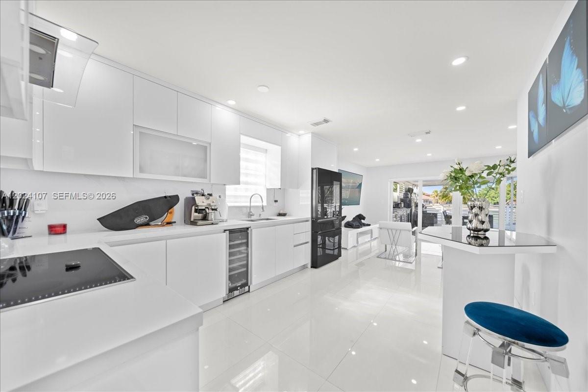 15341 Southwest 36th Street Miami, FL 33185 - Photo 13 of 56 a kitchen with white cabinets and white appliances
