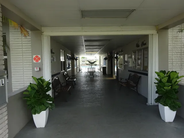 a lobby with furniture and potted plant