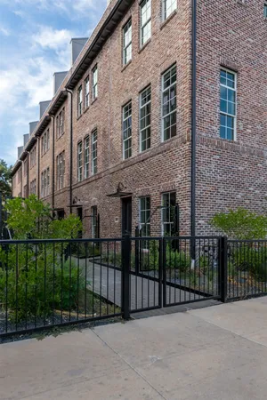a view of a brick building next to a yard