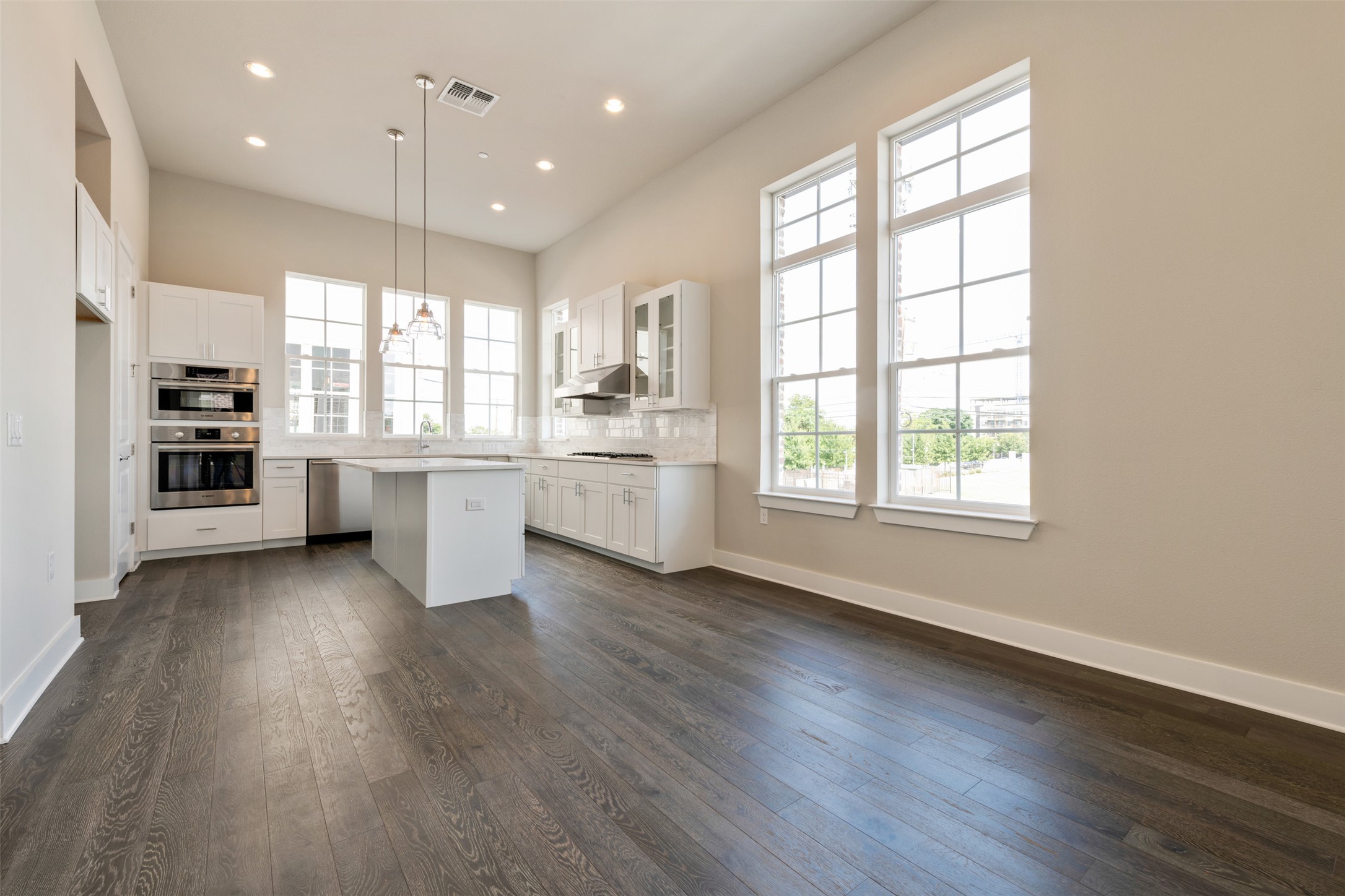 1308 Tinnin Ford Road, Unit 1 Austin, TX 78741 - Photo 6 of 21 an empty room with wooden floor and windows