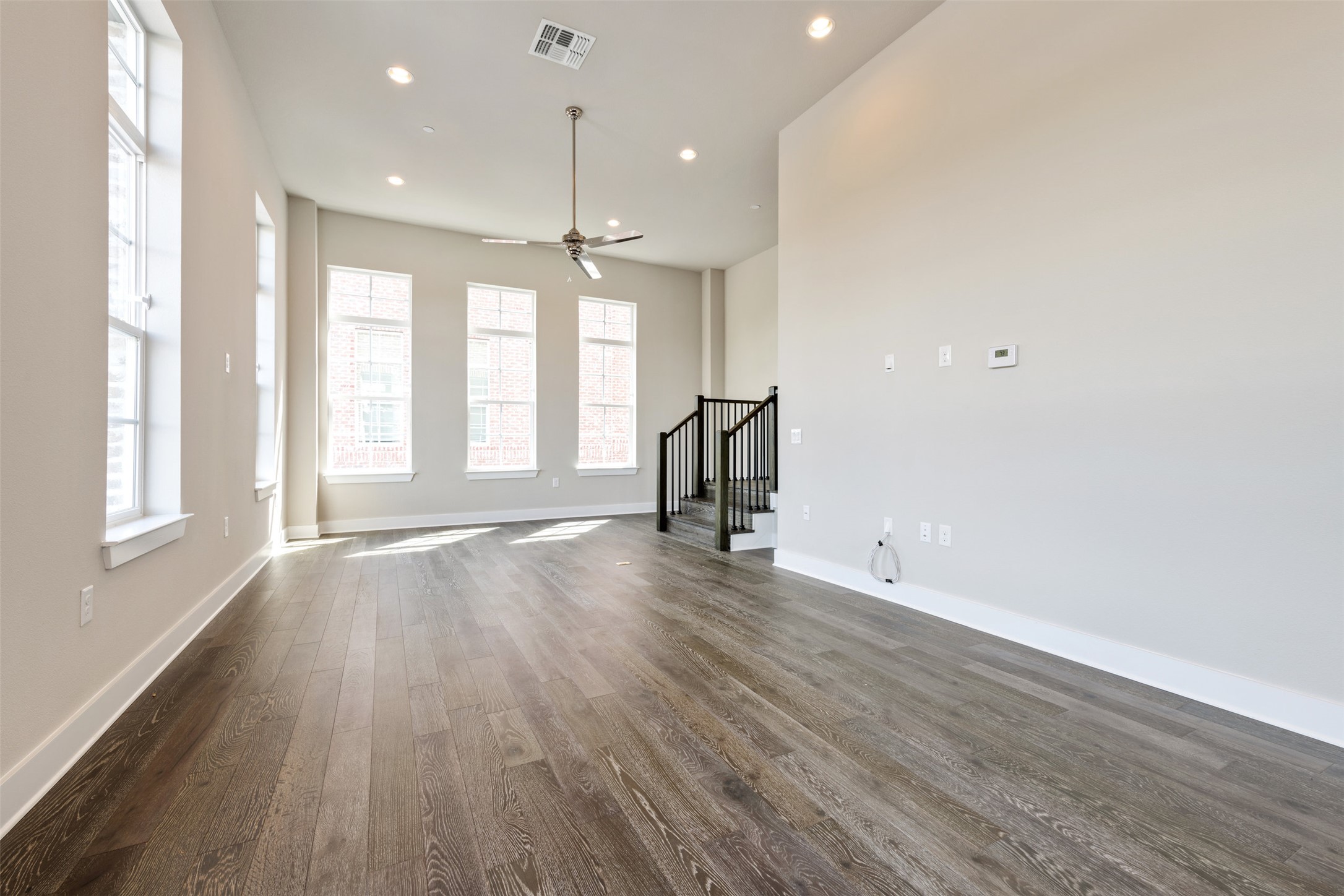 1308 Tinnin Ford Road, Unit 1 Austin, TX 78741 - Photo 9 of 21 an empty room with wooden floor and windows