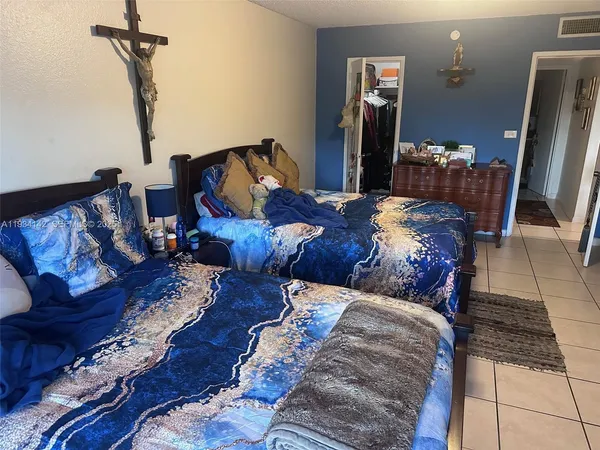 a bedroom with bed and wooden floor