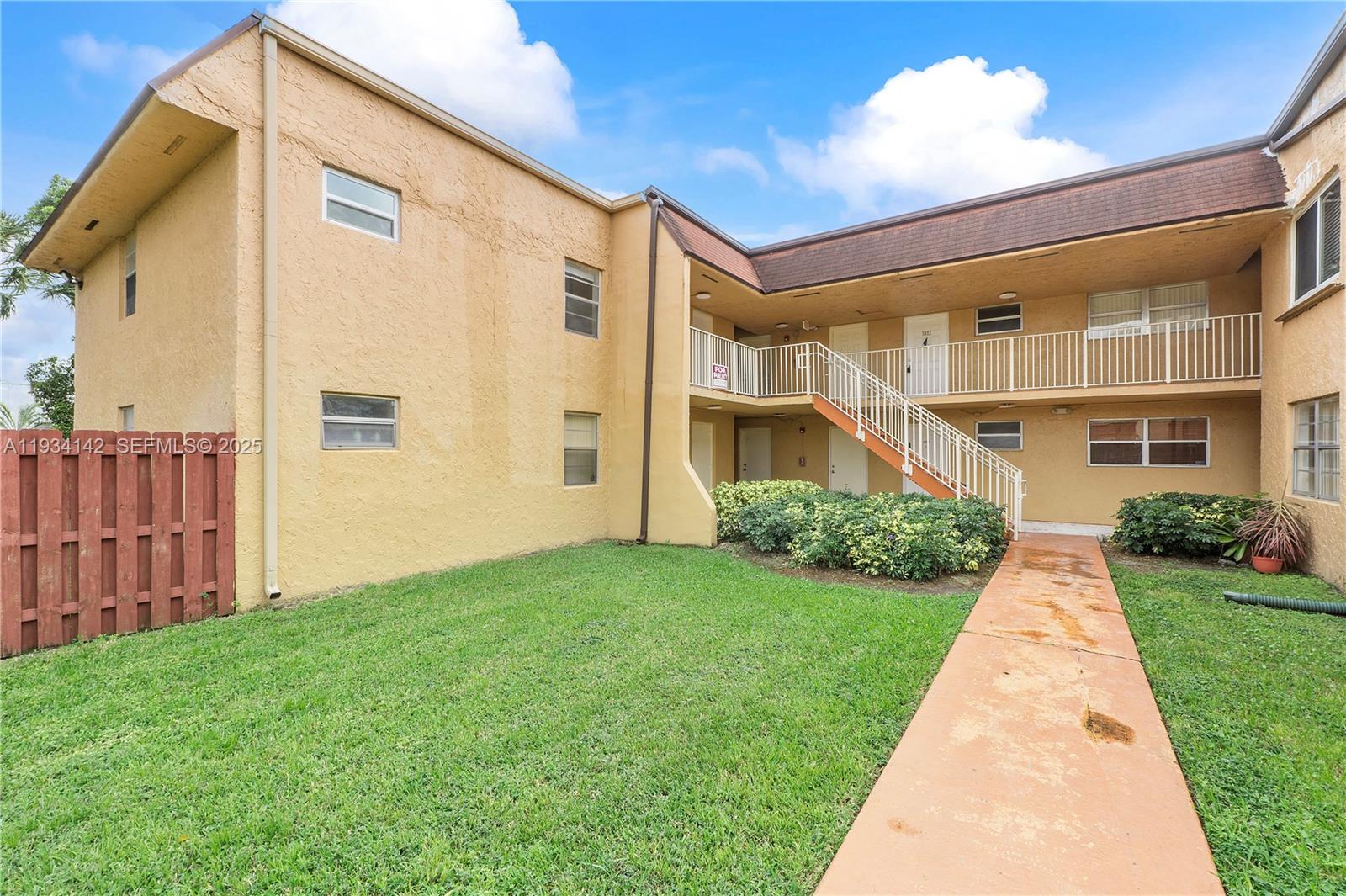9974 Southwest 88th Street, Unit 1028 Miami, FL 33176 - Photo 2 of 24 a front view of a house with yard