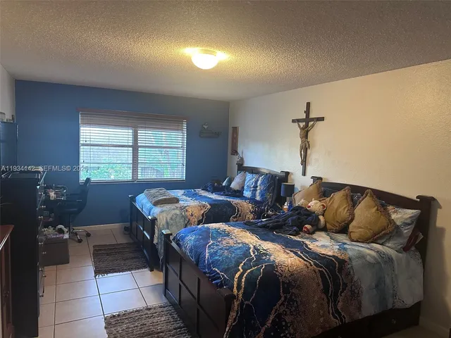 a bedroom with two beds and a window