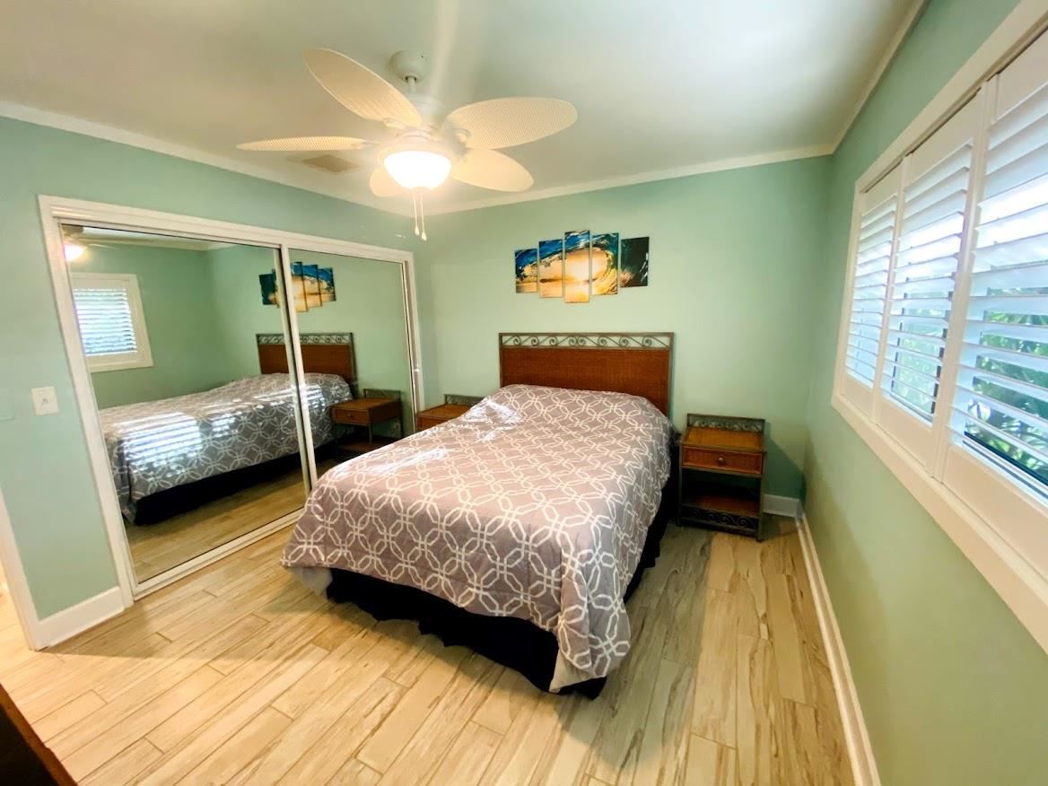 3788 Lower Honoapiilani Road, Unit F103 Lahaina, HI 96761 - Photo 12 of 25 a bedroom with a bed and a large window with outer view