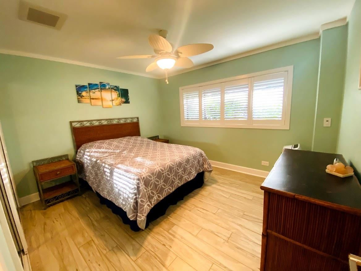 3788 Lower Honoapiilani Road, Unit F103 Lahaina, HI 96761 - Photo 13 of 25 a bedroom with a bed and window