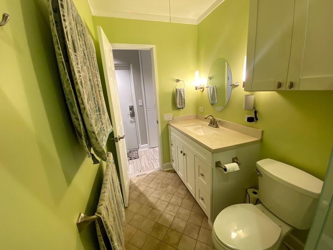 3788 Lower Honoapiilani Road, Unit F103 Lahaina, HI 96761 - Photo 16 of 25 a bathroom with a sink a toilet and a mirror