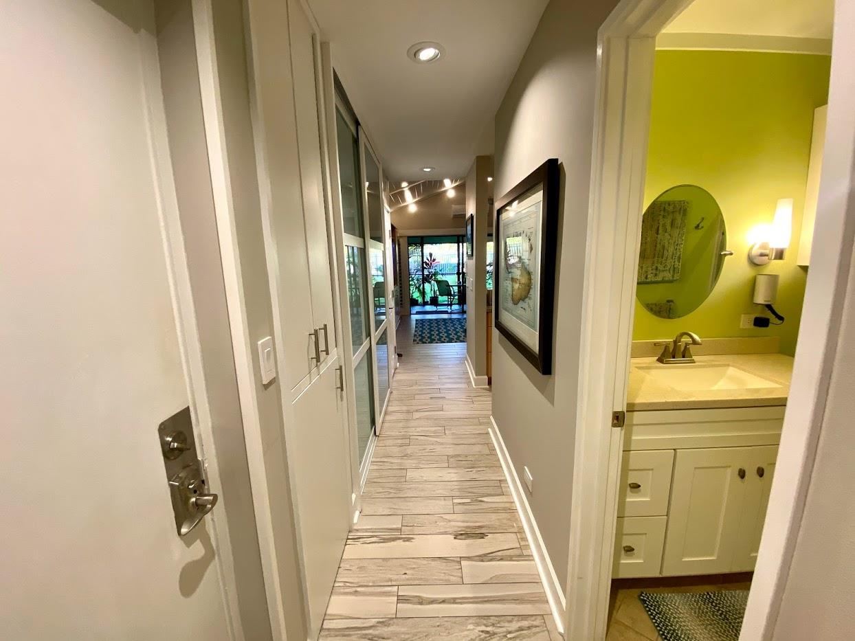 3788 Lower Honoapiilani Road, Unit F103 Lahaina, HI 96761 - Photo 3 of 25 a view of a hallway with wooden floor and staircase