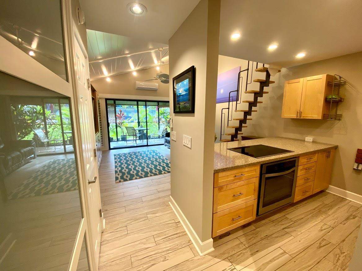 3788 Lower Honoapiilani Road, Unit F103 Lahaina, HI 96761 - Photo 8 of 25 a kitchen with stainless steel appliances granite countertop a stove and a refrigerator