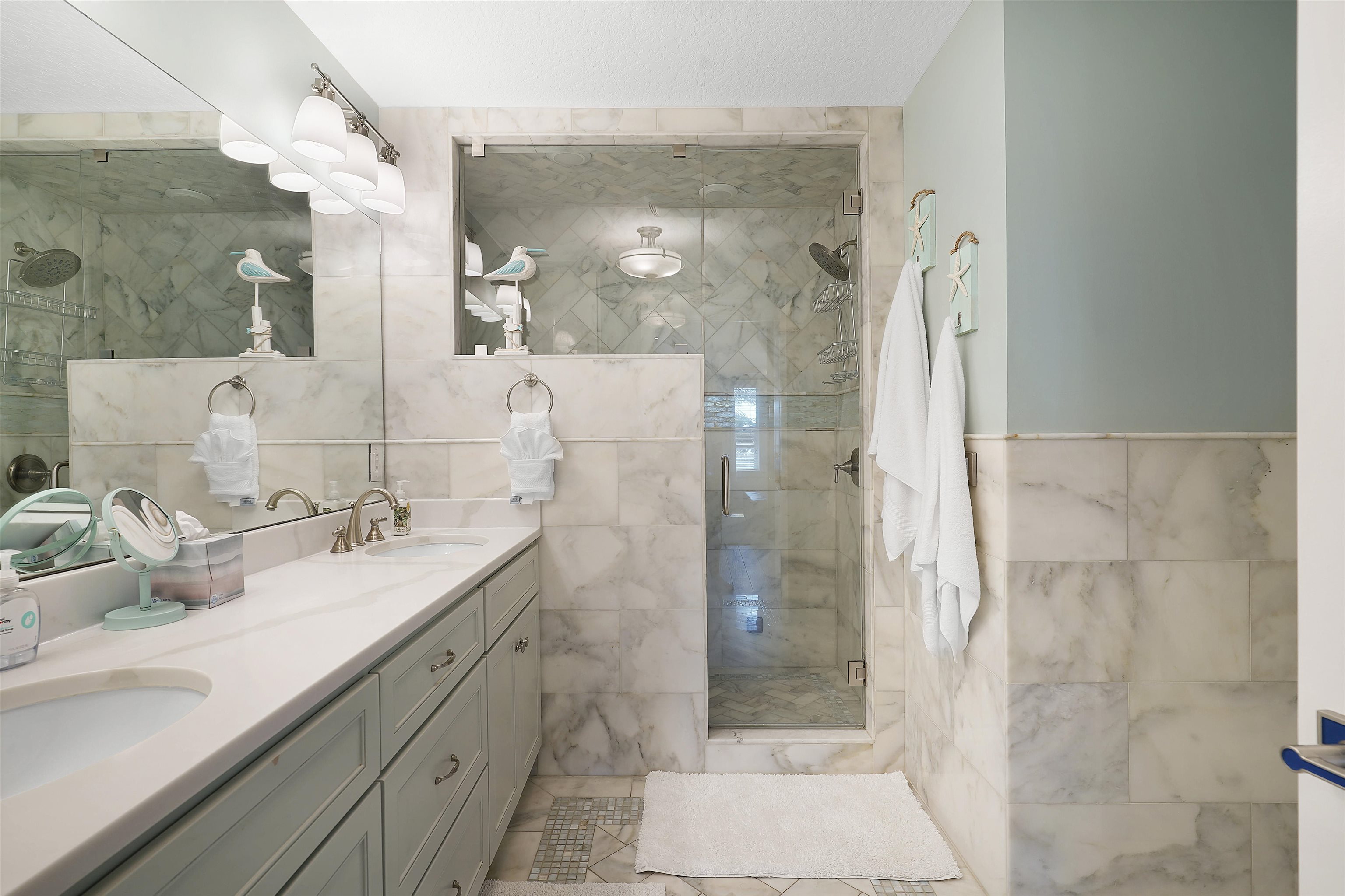 1 2nd Lane St. Augustine Beach, FL 32080 - Photo 22 of 81 a bathroom with a shower sink and mirror