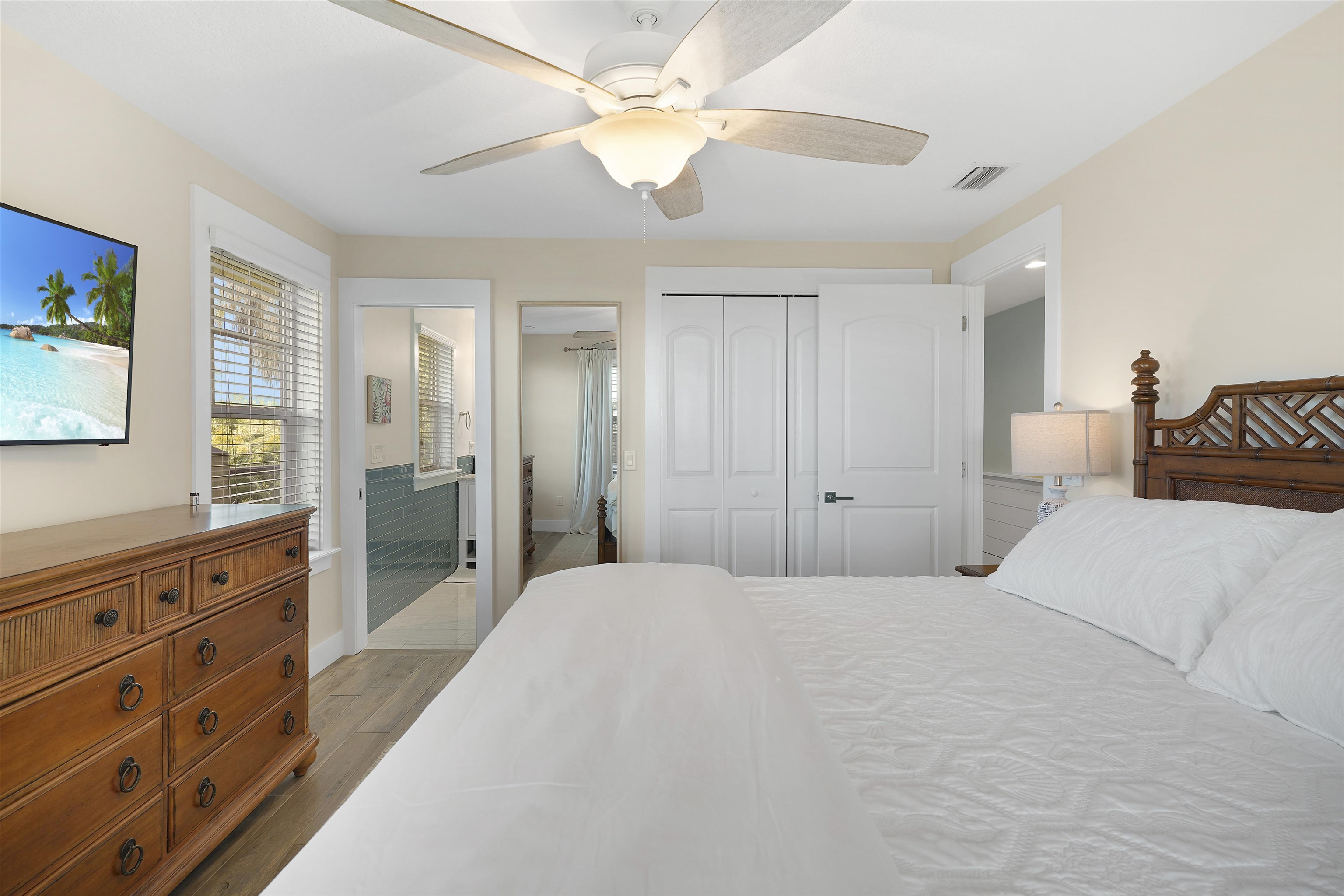 1 2nd Lane St. Augustine Beach, FL 32080 - Photo 32 of 81 a bedroom with a bed a chandelier and a dresser