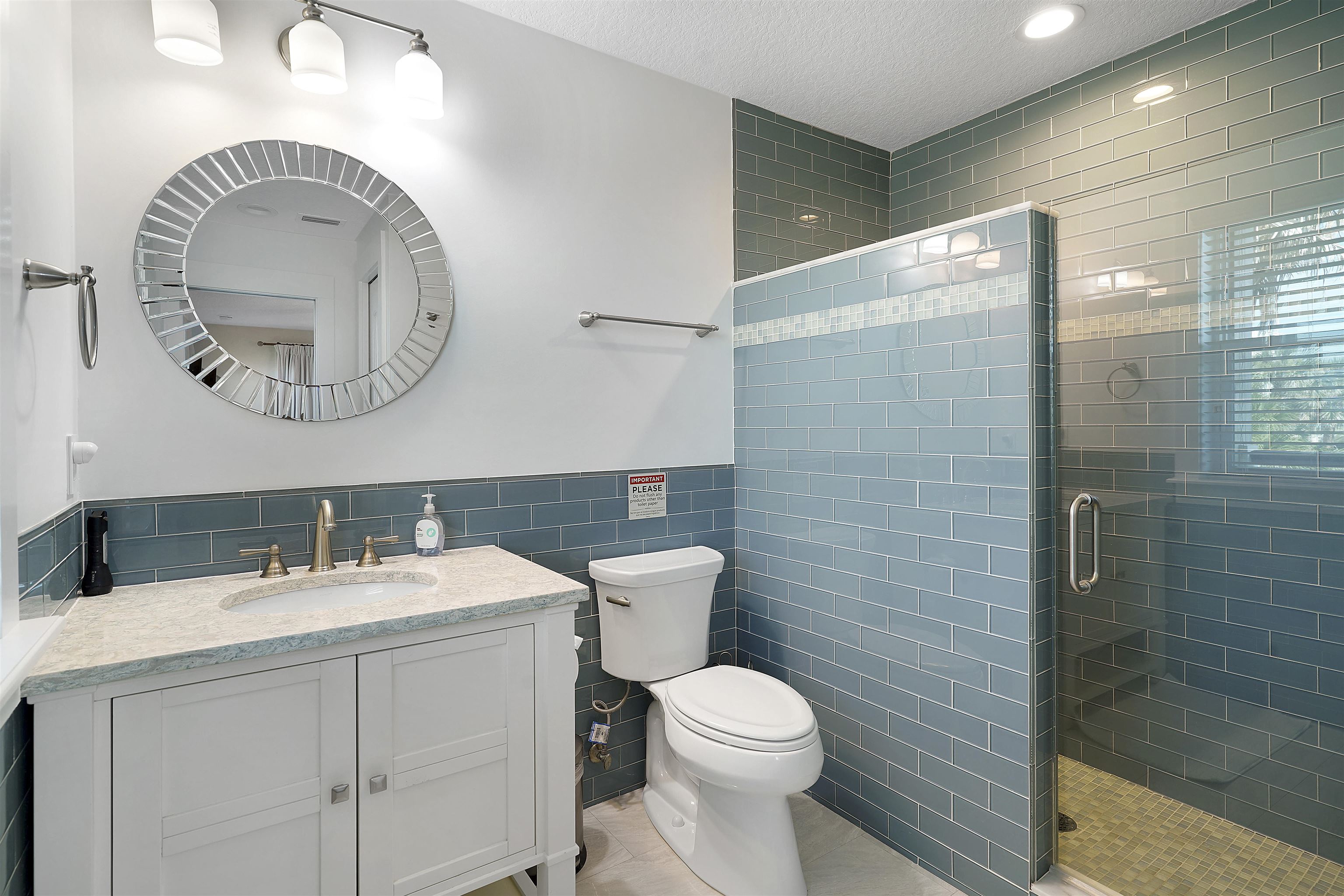 1 2nd Lane St. Augustine Beach, FL 32080 - Photo 33 of 81 a bathroom with a toilet a sink and mirror