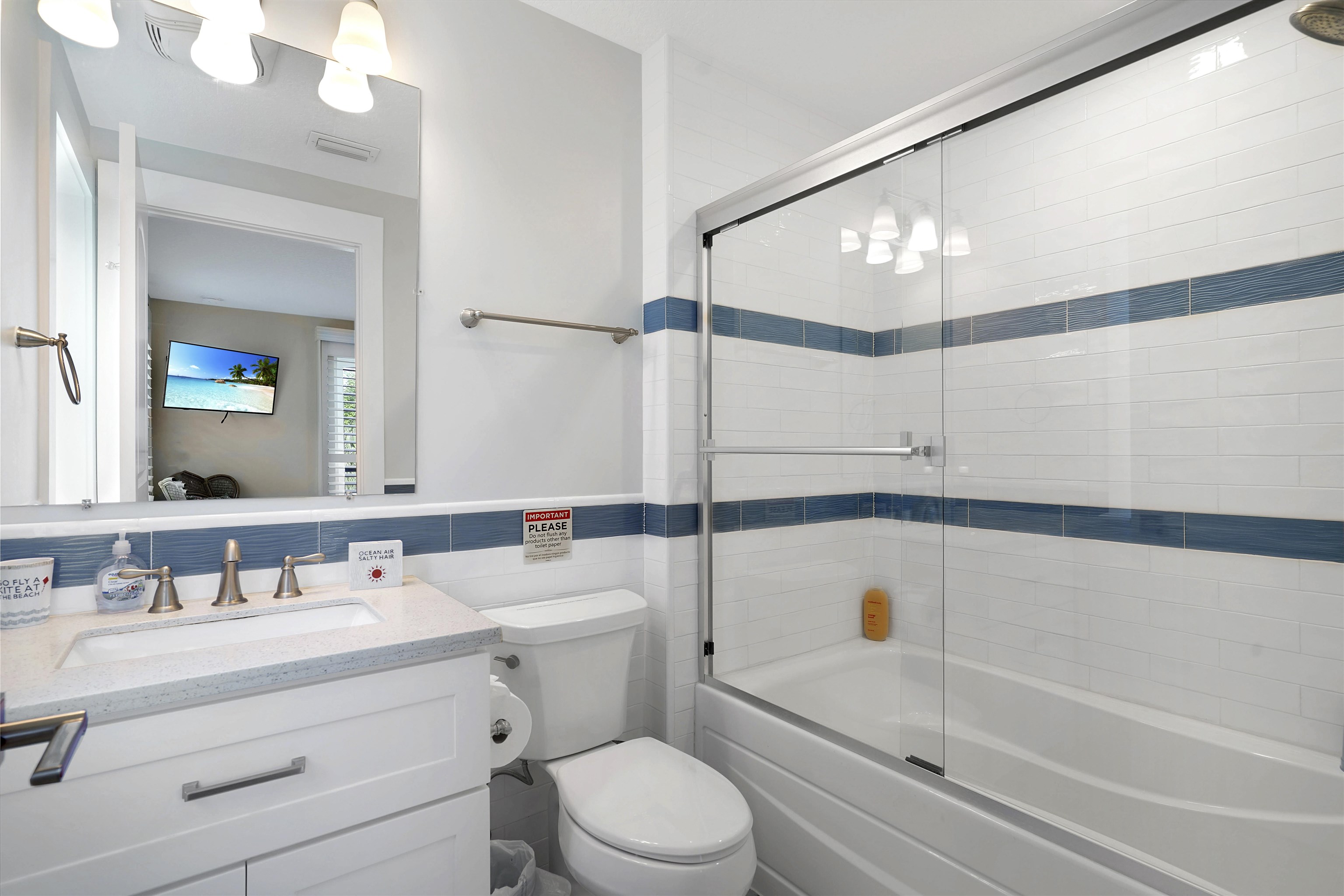 1 2nd Lane St. Augustine Beach, FL 32080 - Photo 37 of 81 a bathroom with a sink a mirror toilet and bathtub