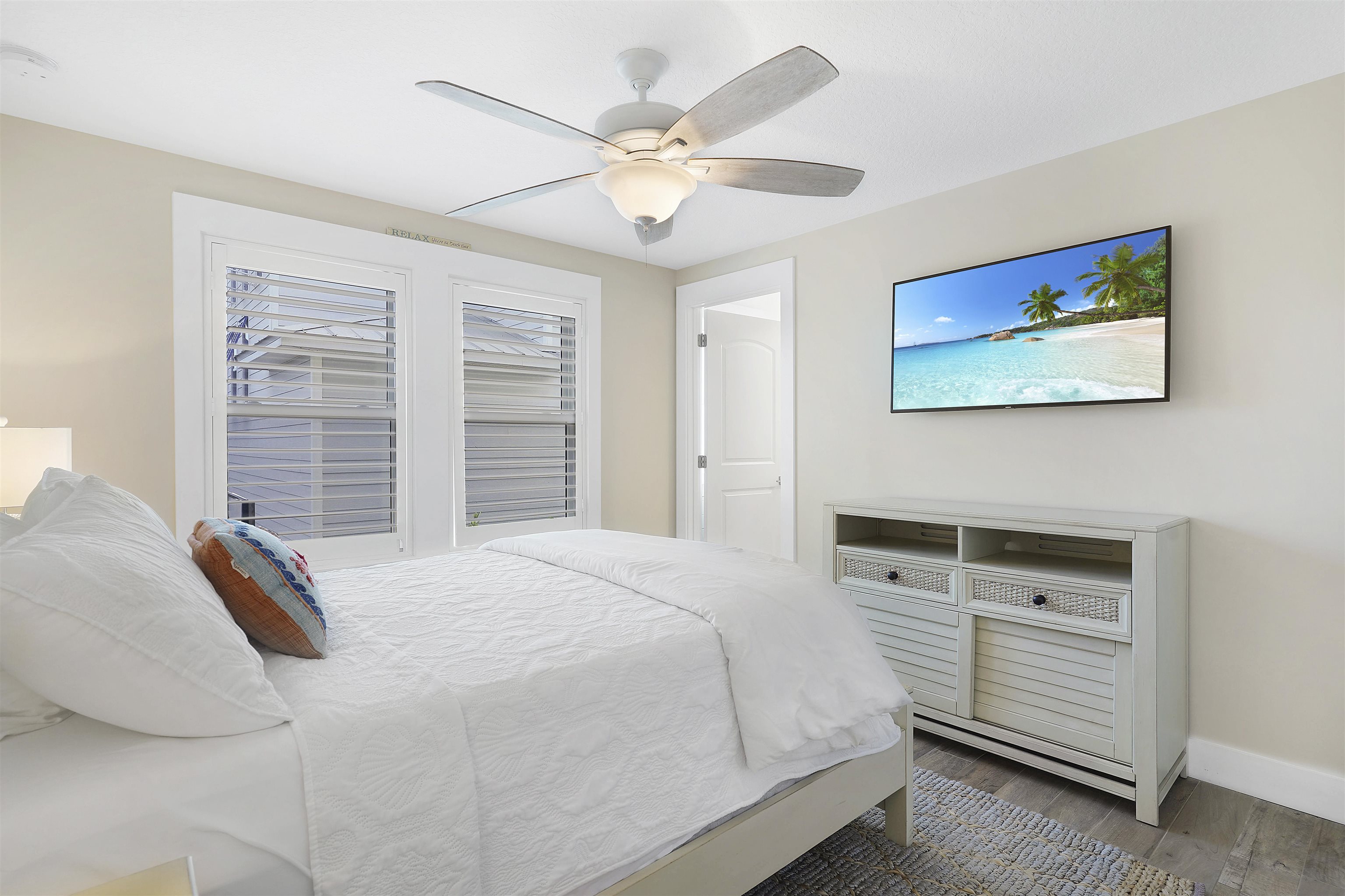1 2nd Lane St. Augustine Beach, FL 32080 - Photo 38 of 81 a bedroom with a bed and a ceiling fan