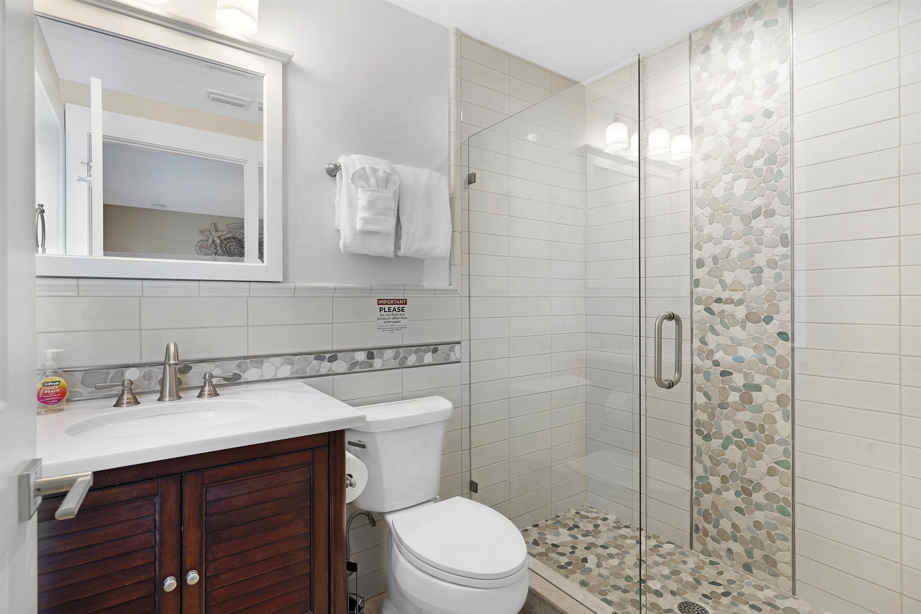 1 2nd Lane St. Augustine Beach, FL 32080 - Photo 40 of 81 a bathroom with a sink vanity mirror and toilet