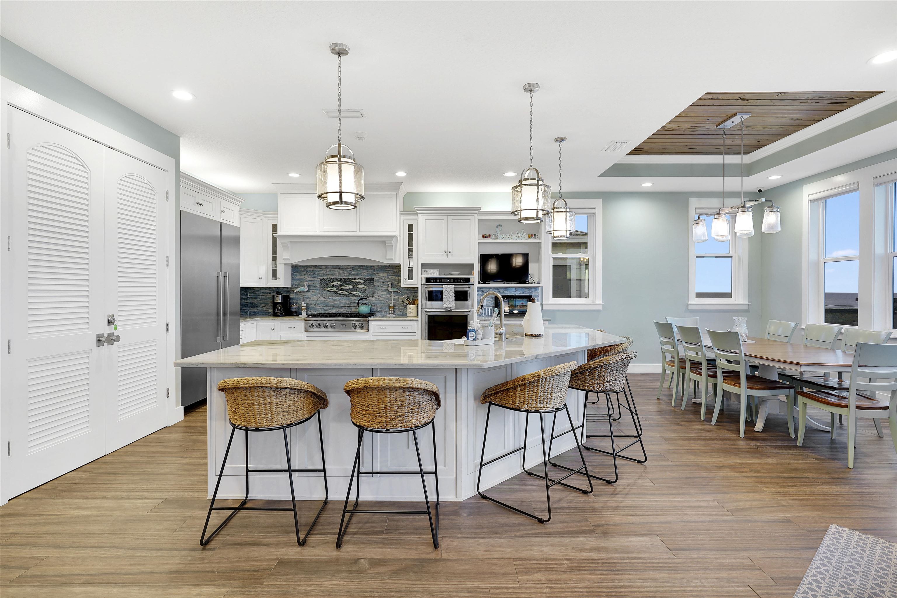 1 2nd Lane St. Augustine Beach, FL 32080 - Photo 4 of 81 a kitchen with stainless steel appliances granite countertop a dining table chairs and white cabinets
