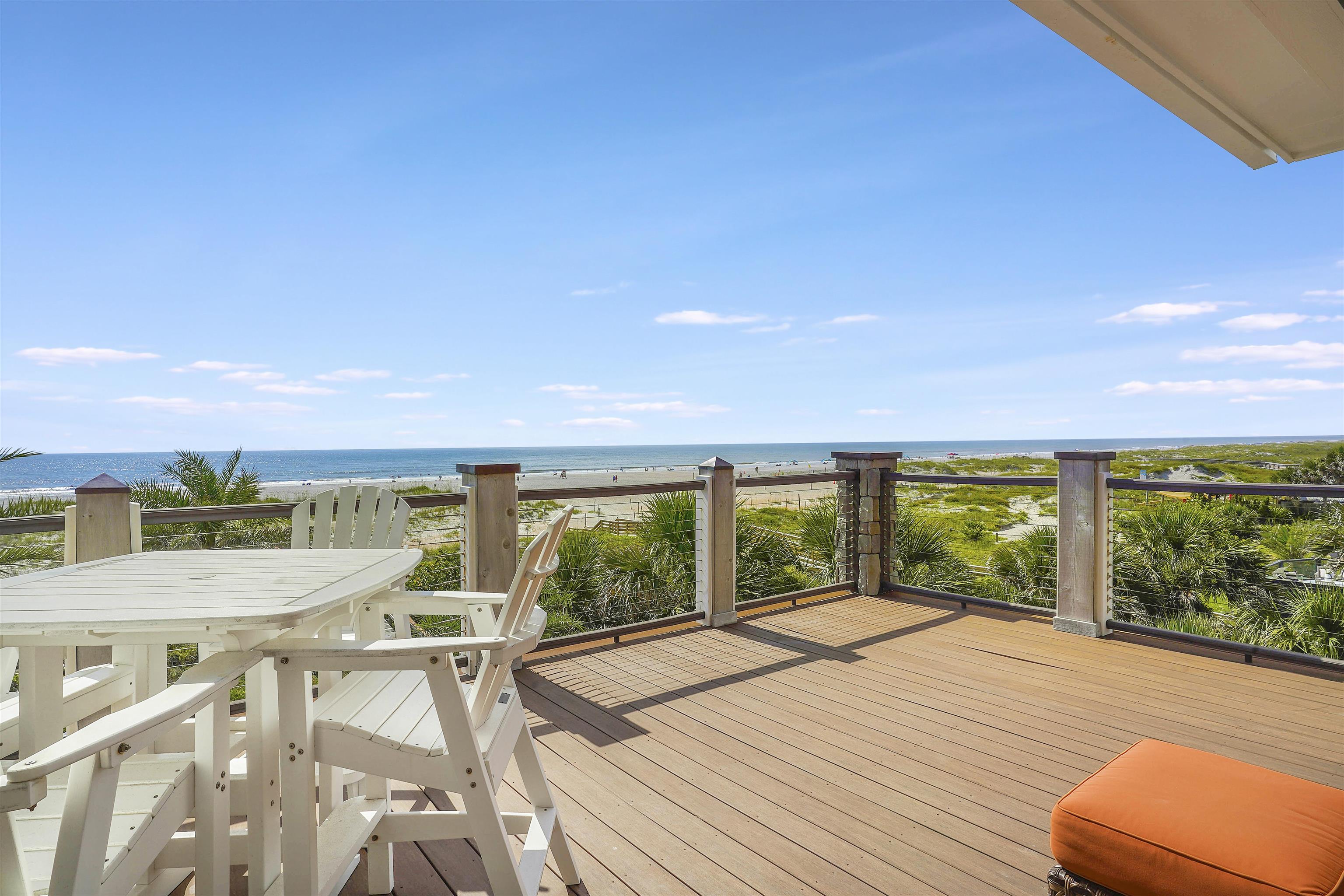1 2nd Lane St. Augustine Beach, FL 32080 - Photo 57 of 81 a view of a patio with lawn chairs floor to ceiling window and yard
