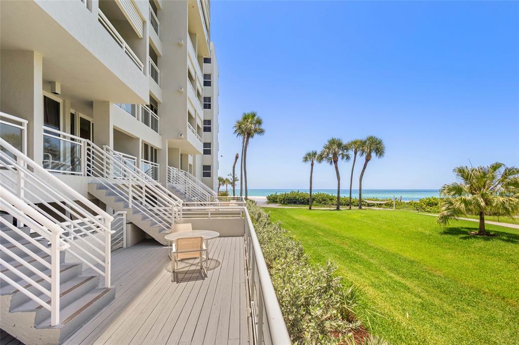 240 Sands Point Road, Unit 4104 Longboat Key, FL 34228 - Photo 28 of 47 a view of a swimming pool with a garden