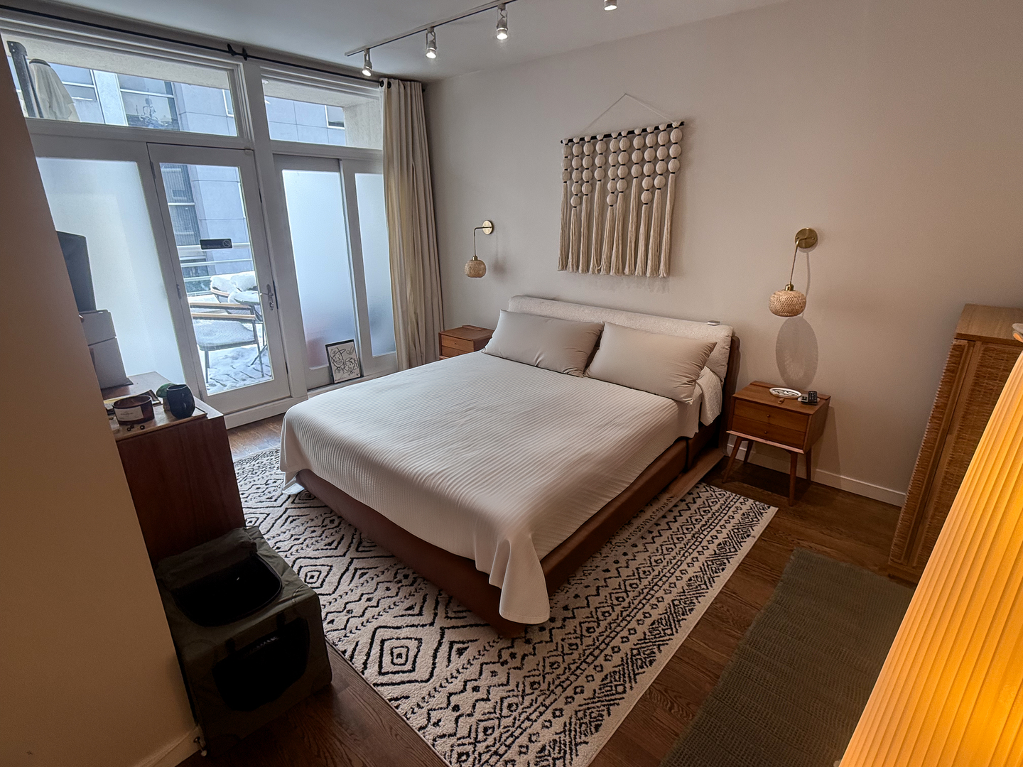 943 West Huron Street, Unit E Chicago, IL 60642 - Photo 17 of 22 a bedroom with a bed and wooden floor