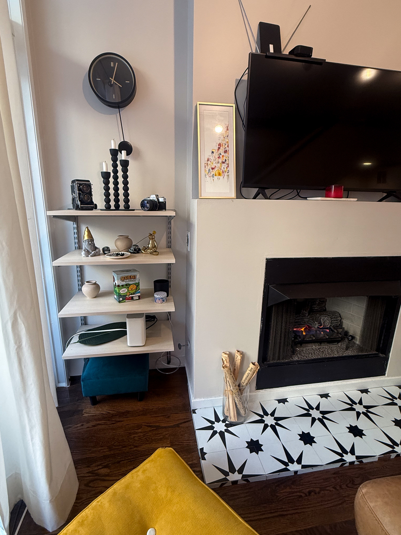 943 West Huron Street, Unit E Chicago, IL 60642 - Photo 18 of 22 a living room with furniture and a flat screen tv