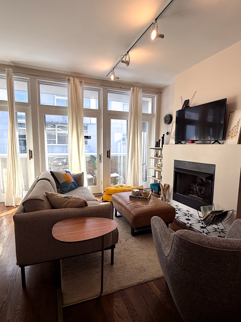 943 West Huron Street, Unit E Chicago, IL 60642 - Photo 5 of 22 a living room with fireplace furniture and a flat screen tv