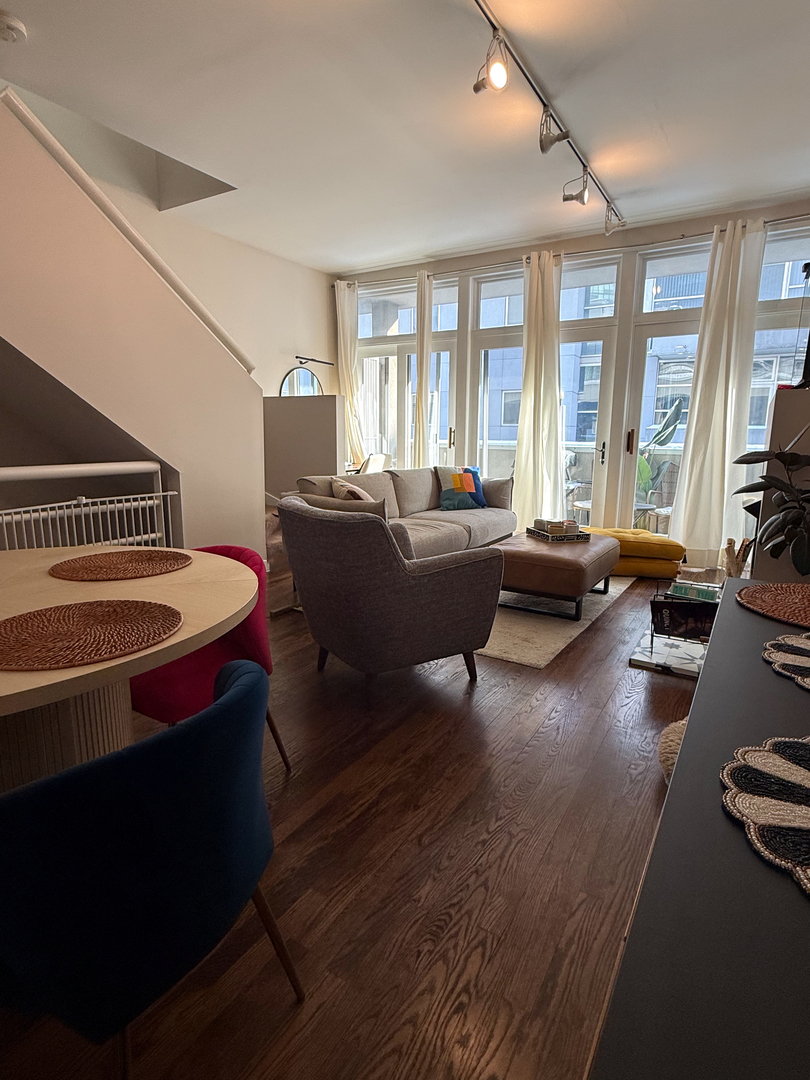943 West Huron Street, Unit E Chicago, IL 60642 - Photo 7 of 22 a living room with furniture and a large window