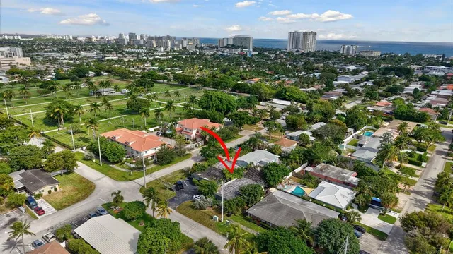 an aerial view of residential houses with city view