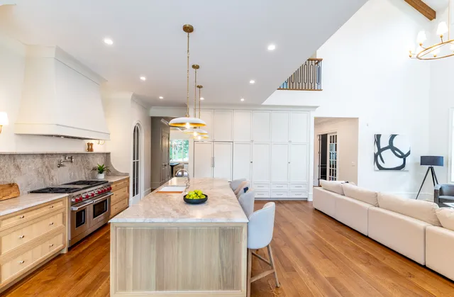 a view of a kitchen with stainless steel appliances granite countertop a stove and a refrigerator